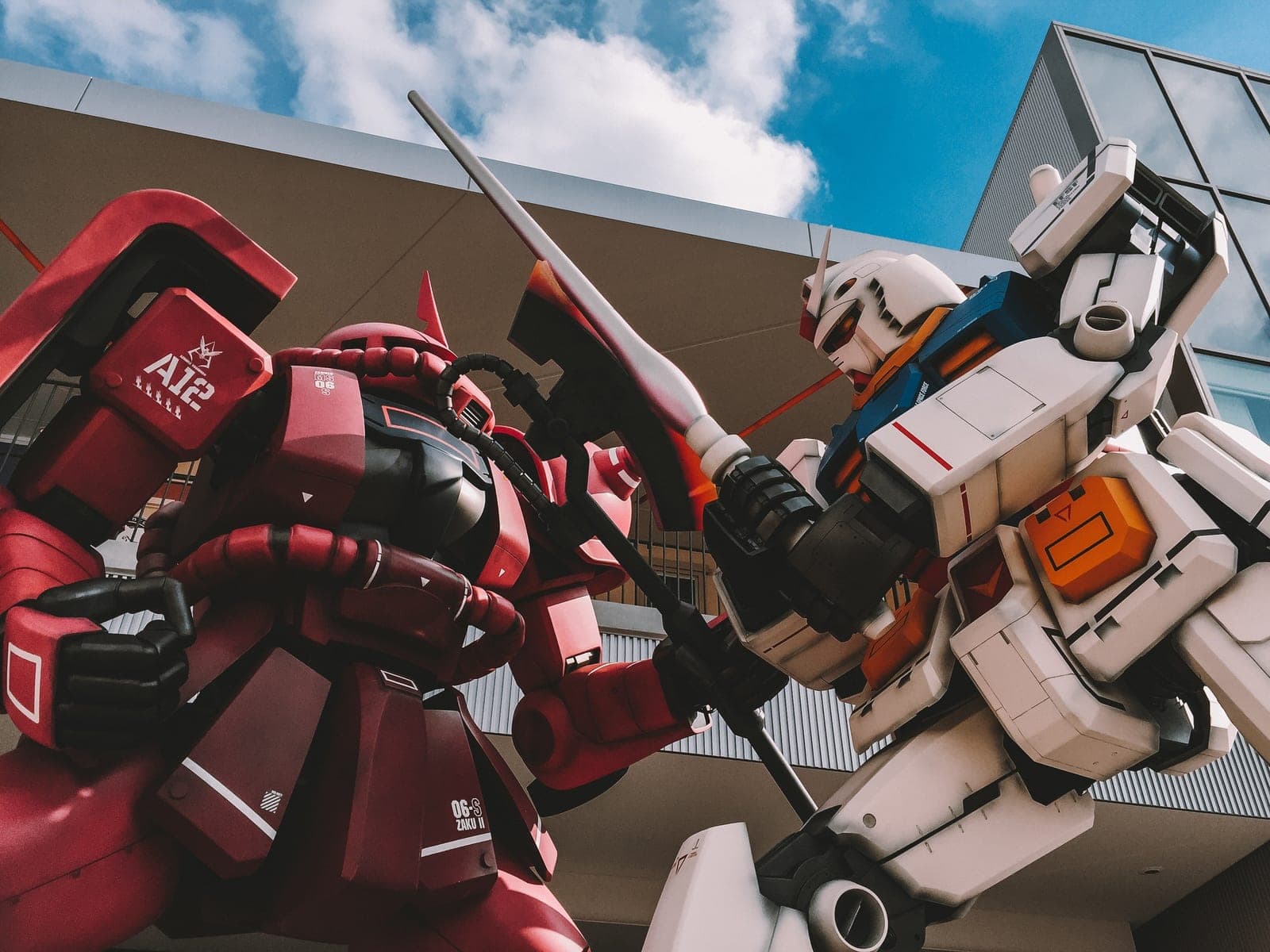 Two robots battling each other in front a building
